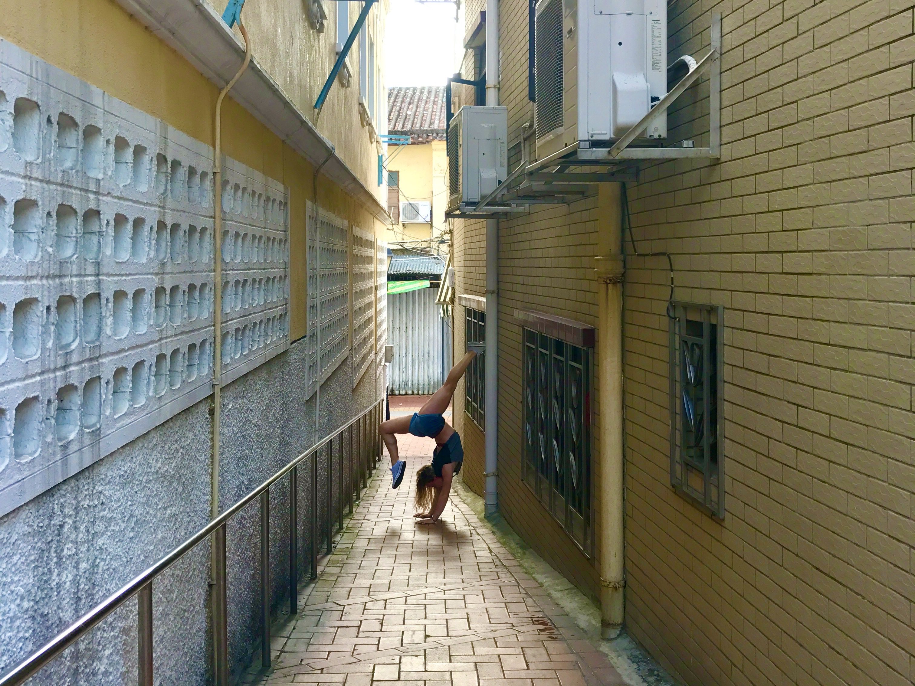Sammie doing a handstand in the streets of Macau